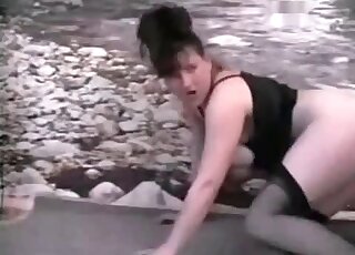 Naked brunette bends down to welcome her doggie for a hot fuck